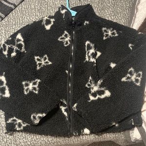 black cropped jacket with white butterfly designs